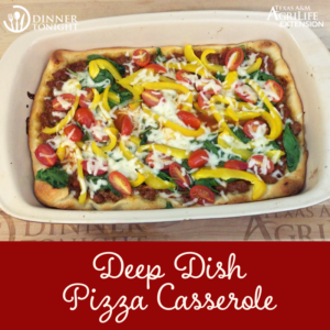 Deep Dish Pizza Casserole just out of the oven in a ceramic casserole dish. Bright yellow peppers, red cherry tomatoes, and green spinach.