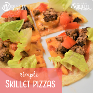 One Skillet Pizza topped with beef, cheese, tomatoes and lettuce sliced and ready to be eaten!