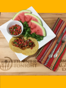 image of shrimp tacos with watermelon salsa on cutting board with yellow background