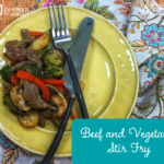 Beef and Vegetable Stir Fry plated on a yellow plate, with a paisley napkin.