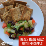 Black bean salsa with pineapple, plated with crackers.