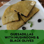 Quesadillas filled with mushrooms and black olives, cheese, and green onions on a white plate on a wooden cutting board.