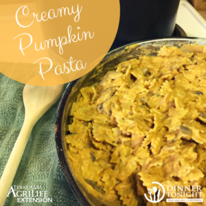 Bowtie pasta covered in a creamy pumpkin sauce still in the saucepan it was cooked in.