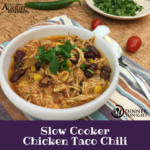 Slow Cooker Chicken Taco chili recipe in a bowl topped with cilantro.