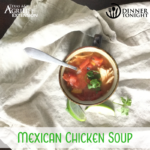 Mexican Chicken Soup recipe in bowl with sides of cilantro and lime wedges.